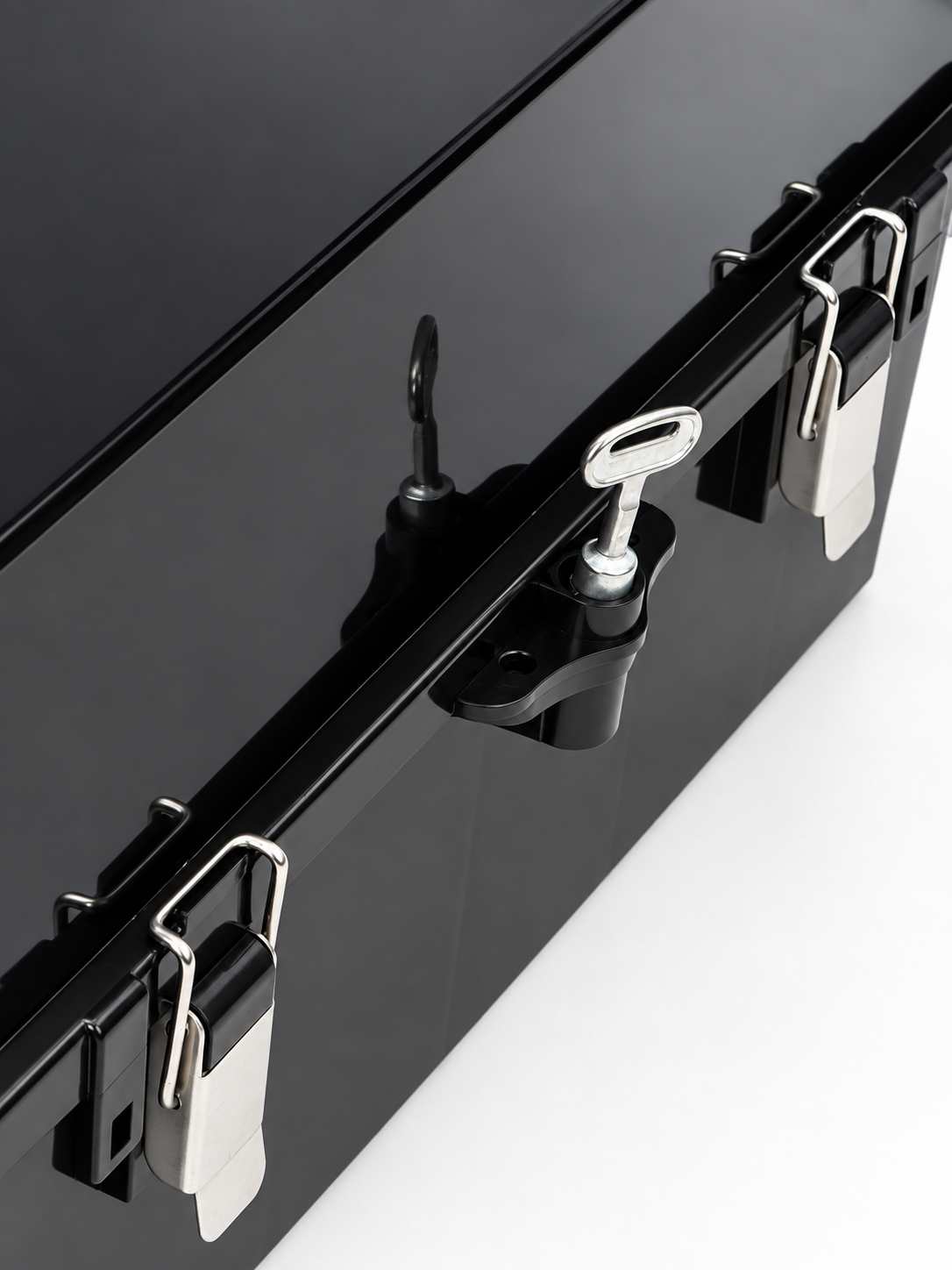 Close-up of the closed black enclosure with its stainless latches and locking handle